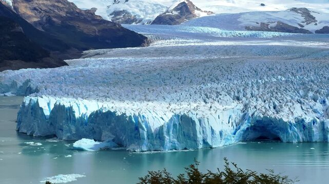Aerial drone footage of Perito Moreno Glacier in Patagonia, Argentina, showing massive blue ice wall and turquoise water