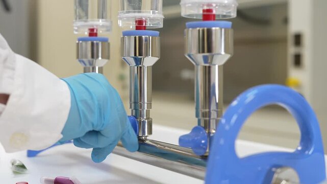Scientist opening valves of multi-branch filtration manifold with three membrane filter units to start vacuum