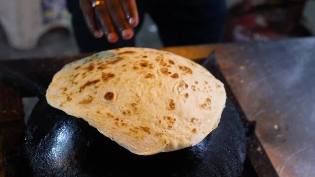 Indian street food paratha making on tawa for kebab paratha