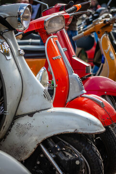 Berlin, Germany  - 03 October 2026: Colorful "Vespa" Scooters and other Retro Scooters in a Row, Close-up