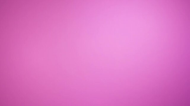 A soft gradient of vibrant pink creates a dreamy, ethereal background, perfect for adding a touch of color and elegance to any design project.