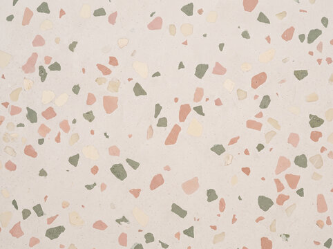 Pastel terrazzo surface with pink green and cream stone chips