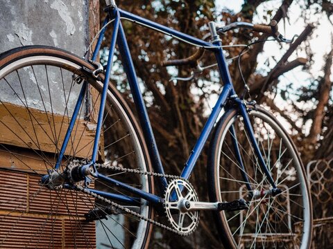 Vintage blue bicycle photographed outdoors