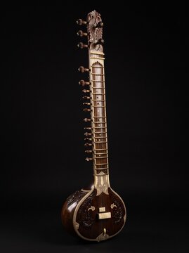 Detailed close-up of a traditional sitar highlighting its strings, wooden body, frets, craftsmanship, and rich cultural musical heritage.