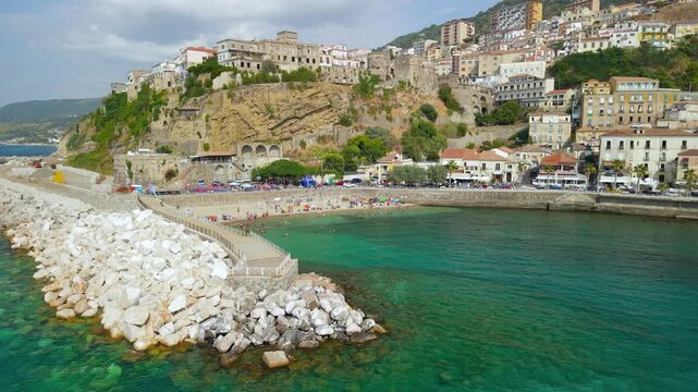 Pizzo Calabria Italy 4k drone view of Murat castle on cliff over turquoise sea. Left to right pan of historic borgo, small sandy beach broll establishing scenic video footage Costa degli Dei
