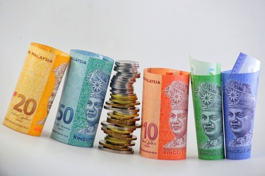 Ringgit Malaysia currency notes with coins