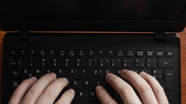 Horizontal Top-Down View of Person Typing on Black Laptop Keyboard