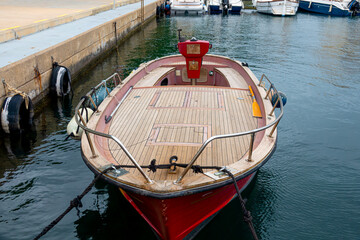 A boat is tied up at a pier near other boats © Iryna