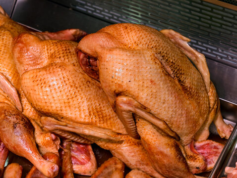 Ducks arranged on a supermarket meat counter present fresh poultry products with natural protein and fat content for everyday culinary preparation