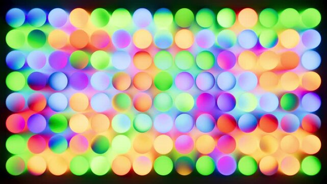 Field of glowing neon circles in rainbow hues animates in a rhythmic wave. Vibrant bokeh loop for dynamic backgrounds.