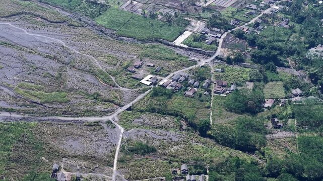 High angle aerial massive volcanic mudflow deposits in a ruined Lumajang district.
