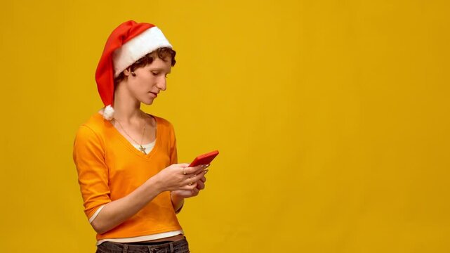 Young woman wearing santa hat taking selfies