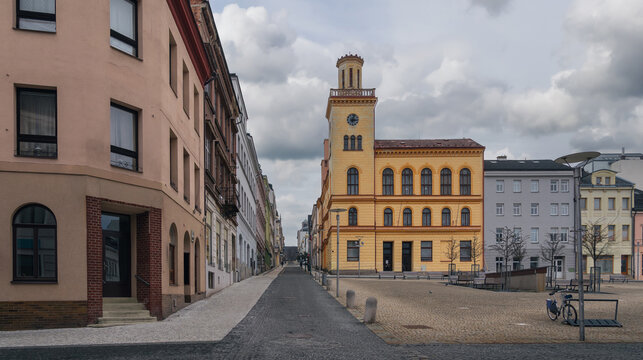 Old Town Hall and surrounding historic street in Jablonec nad Nisou, Liberec Region, Czech Republic, showing the yellow facade, tower, square and nearby buildings.
