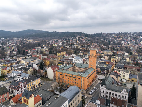 Aerial view of Jablonec nad Nisou, Liberec Region, Czech Republic, centered on the New Town Hall and surrounded by dense urban blocks and wooded hills.