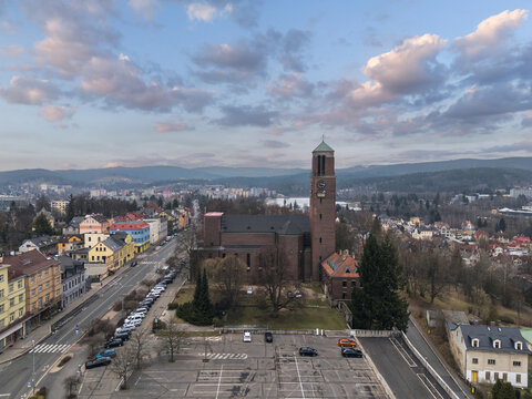 Church of the Sacred Heart of Jesus in Jablonec nad Nisou, Liberec Region, Czech Republic, viewed from above with its brick tower, surrounding streets and hills.