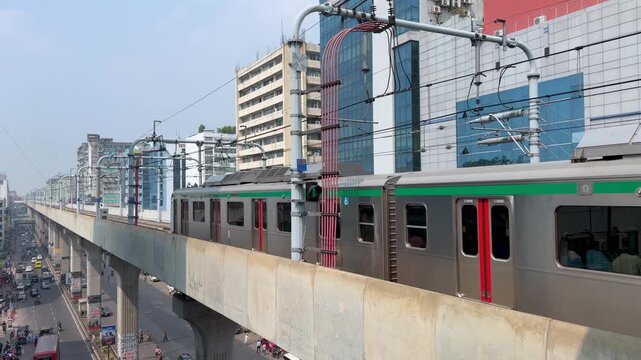 Dhaka Metro Rail Train Passing Commercial Buildings on Elevated Tracks, Bangladesh
