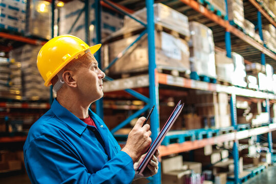 Warehouse worker checks inventory with clipboard