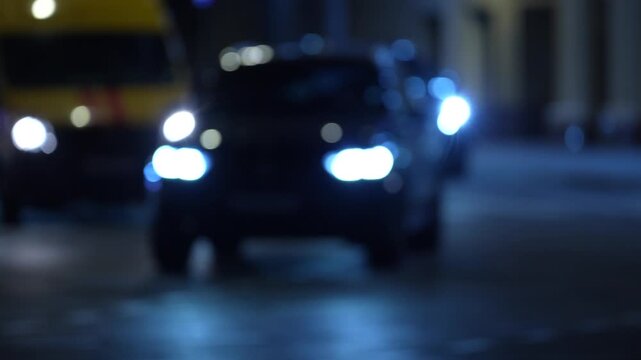 Blurred night traffic with bright headlights on a busy urban road, representing traffic flow, daily commuting, transportation and modern city mobility
