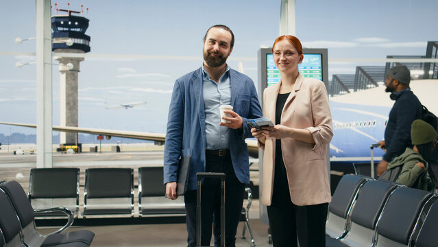 Business associates checking flight details during airport work trip