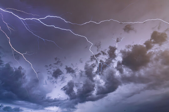 Dramatic Lightning Bolts Striking Across Dark Stormy Night Sky A stormy sky with lightning in the background