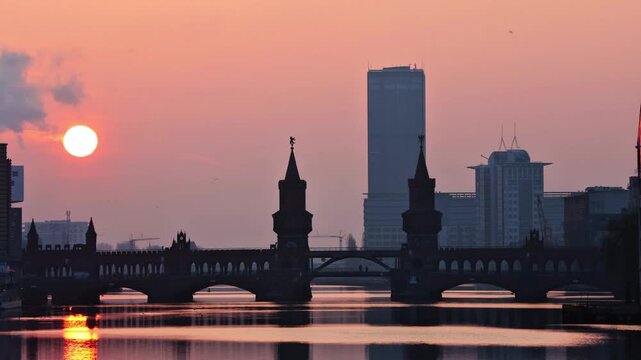 Time-lapse video, view across the Spree to Oberbaum Bridge during sunrise, Berlin, 09/02/2025