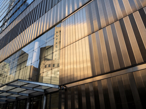 New York City, New York &ndash; October 3, 2026: Metal-clad facade with vertical louvers and a glass entrance canopy on an office building in Lower Manhattan.