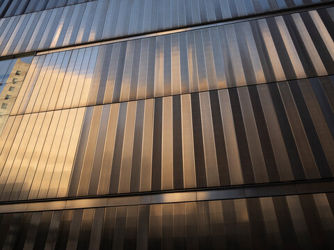 New York City, New York &ndash; October 3, 2026: Vertical metal louvers in sunlight and shadow on the facade of an office building in Lower Manhattan at the World Trade. Center.