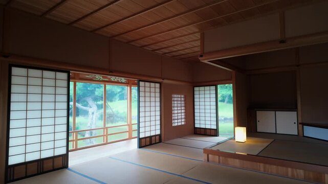 A tranquil, minimalist Japanese room with tatami mats and shoji screens overlooking a lush garden in Hamarikyu Gardens, Tokyo, Japan, embodying Zen elegance.