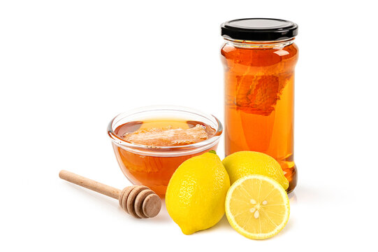 collection of organic honey featuring a glass jar, a bowl of liquid gold, fresh honeycomb, and a wooden dipper. Food photography isolated on white background