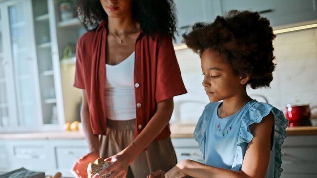 Sifting flour over dough closeup. Family kneading cookie home kitchen.