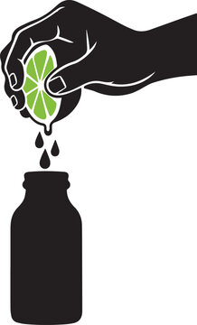 Hand squeezing fresh lime into glass bottle for healthy juice making or cocktail creation.