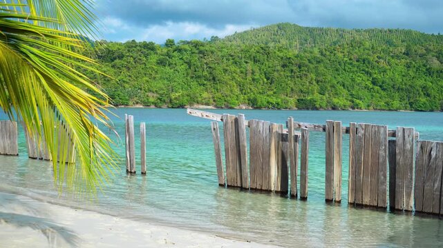 Wooden Posts in Crystal Clear Tropical Bay