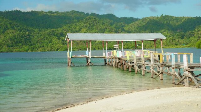 Wooden old Jetty on Calm Tropical Beach