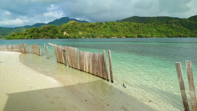 Wooden Fence on Tropical Beach with Turquoise Water