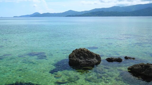 Large Coastal Rock in Calm Tropical Sea