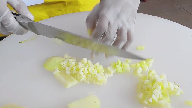 Hand knife cut and slice fresh apple fruit on white board table 