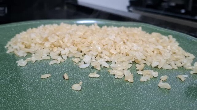 Close up of freshly cooked white rice steaming on a plate, hot homemade food with visible steam and appetizing meal texture