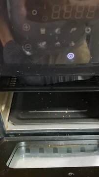 Person removing well-done steak from air fryer, homemade meat preparation with modern kitchen appliance and everyday cooking routine