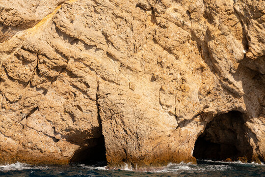 The coastline of Thassos Island. The marine landscape in Greece. Rocks, sea, trees, sky.