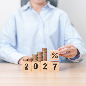 2027 New year with percentage change to UP and Down arrow with coin stack. Interest rate, GDP, stocks market, financial, deflation and Inflation, mortgage, debt, Loan and Economic Recession
