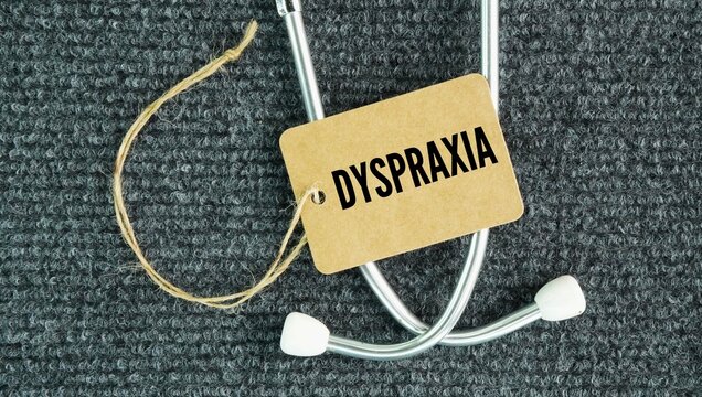 Stethoscope and paper tag with the word Dyspraxia, also known as Developmental Coordination Disorder DCD, is a lifelong neurological condition that affects physical coordination, motor planning, and e