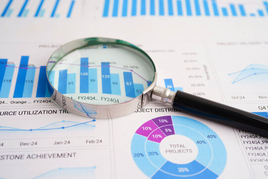 Magnifying glass on charts graphs paper. Financial development, Banking Account, Statistics, Investment Analytic research data economy.