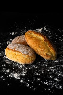 Bread in Shadow": where simplicity becomes sculpture &mdash; golden loaves emerge from darkness, crowned with flour, whispering of oven heat and patient hands. A statement piece for those who taste