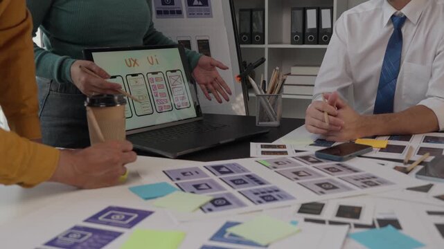 Ux ui designers collaborating on mobile application interface