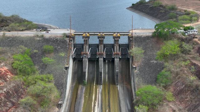 Hydroelectric Dam and Reservoir with Spillway and Energy Infrastructure. Establishing Shot. Aerial View.