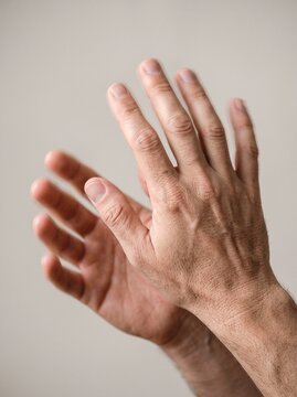 Close-up of hands mid-involuntary movement
