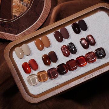 A close-up photograph of various nail polish colors on a tabletop.