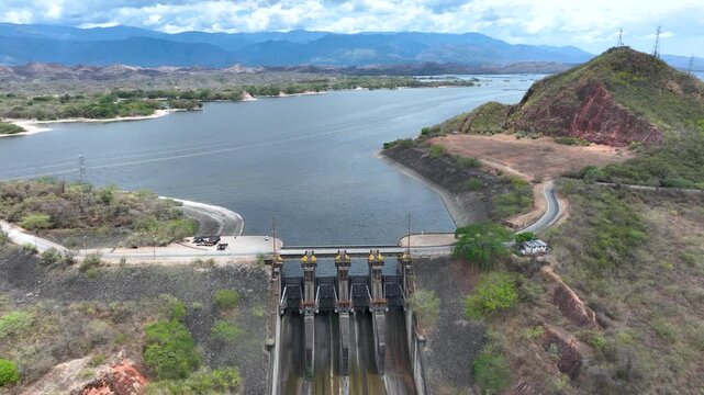 Hydroelectric Dam and Reservoir with Spillway and Energy Infrastructure. Establishing Shot. Aerial View.