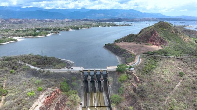 Hydroelectric Dam and Reservoir with Spillway and Energy Infrastructure. Establishing Shot. Aerial View.