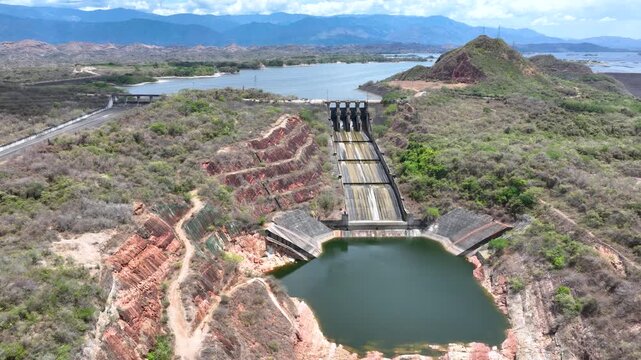 Betania Reservoir and Hydroelectric Dam Surrounded by Mountains in Colombia. Establishing Shot. Aerial View.